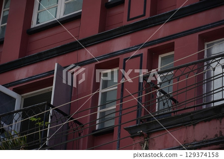 Detailed view of windows, doors and balconies of city buildings  129374158