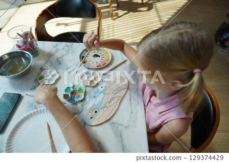 A young mother and her daughter enjoy a creative art session at home A young mother and her daughter enjoy a creative art session at home 129374429