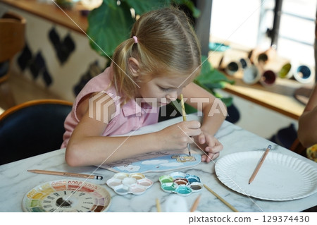 A young mother and her daughter enjoy a creative art session at home A young mother and her daughter enjoy a creative art session at home 129374430