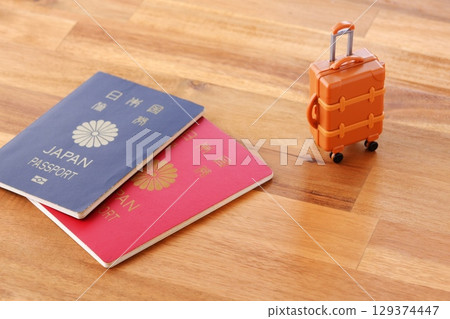 Passport and suitcase - Image of overseas travel with passport (10-year and 5-year) and suitcase 129374447