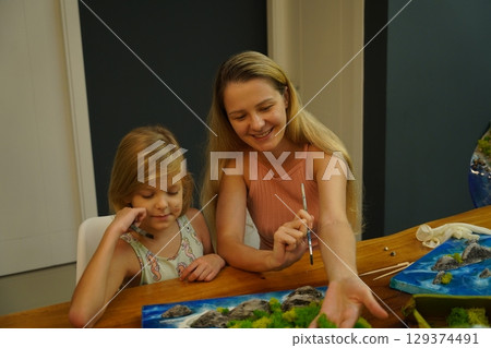 A mother and her daughter craft vibrant natural landscapes A mother and her daughter craft vibrant natural landscapes 129374491