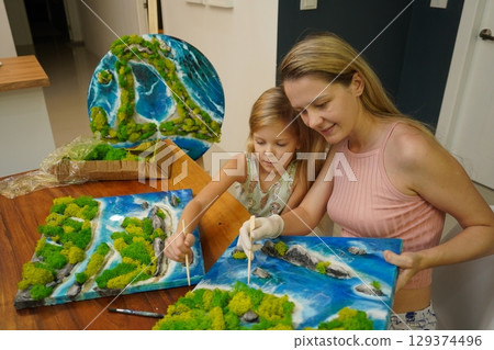 A mother and her daughter craft vibrant natural landscapes A mother and her daughter craft vibrant natural landscapes 129374496