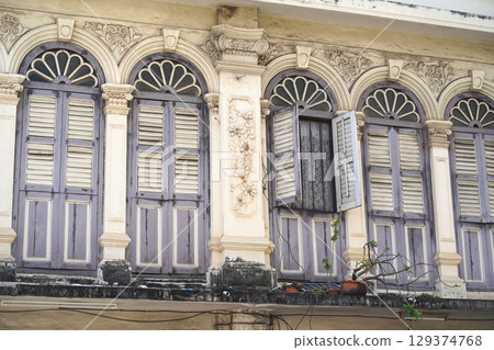 Detailed view of windows, doors and balconies of city buildings  129374768