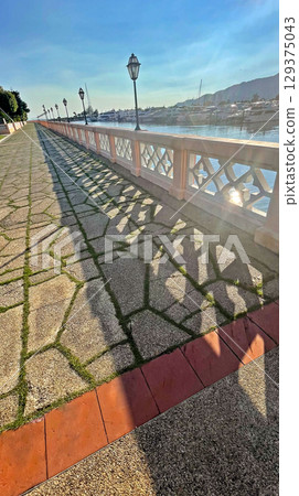 Vertical buildings, outdoor footpath lane near yacht club and the lake Vertical buildings, outdoor footpath lane near yacht club and the lake 129375043