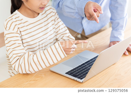 一名中學生和她的父親在家使用電腦 一名中學生和她的父親在家使用電腦 129375056