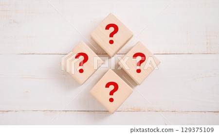 Group of Wooden Blocks with Red Question Marks Arranged on White Rustic Wooden Table Business Concept Group of Wooden Blocks with Red Question Marks Arranged on White Rustic Wooden Table Business Concept 129375109