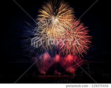 Fireworks in the summer sea night sky Fireworks in the summer sea night sky 129375438