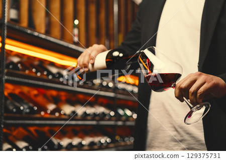 Red Wine Stream Mid-Pour in Wine Cellar Red Wine Stream Mid-Pour in Wine Cellar 129375731
