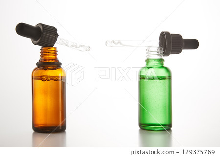 Aromatherapy brown and green open dropper bottles mockups. Aromatherapy brown and green open dropper bottles mockups. 129375769