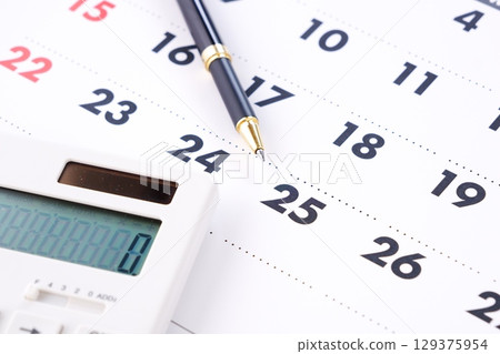 An image of someone staring at the calendar, tapping on a calculator, and eagerly waiting for the 25th, payday. 129375954