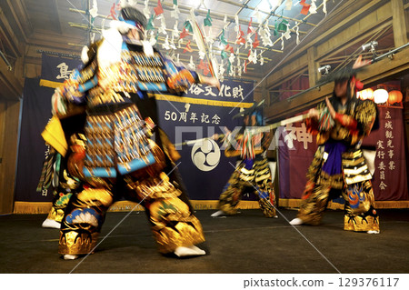 Iwami Kagura (Night Kagura) Performers dancing on the shrine's worship hall stage Iwami Kagura (Night Kagura) Performers dancing on the shrine's worship hall stage 129376117