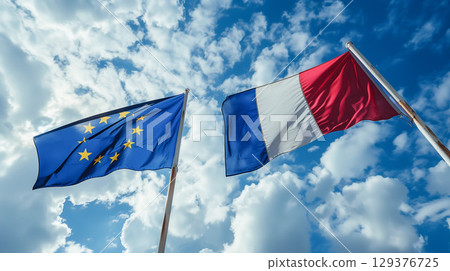 France and EU flag waving on cloudy sky. France and EU flag waving on cloudy sky. 129376725