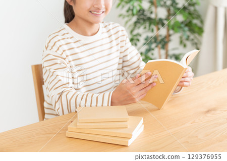 A middle school girl reading at home A middle school girl reading at home 129376955