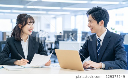 Young employees having a meeting with smiles Young employees having a meeting with smiles 129378249
