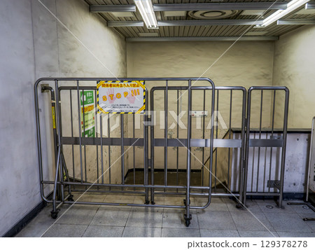 Barricades and a "No Entry" sign in an emergency evacuation passage at an underground train station (JR Bakurocho Station) Barricades and a "No Entry" sign in an emergency evacuation passage at an underground train station (JR Bakurocho Station) 129378278