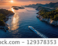 A luxury yacht sailing between islands in the sea drone shot. 129378353