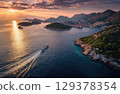 A luxury yacht sailing between islands in the sea drone shot. 129378354