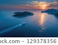 A luxury yacht sailing between islands in the sea drone shot. 129378356