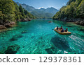 friends on a yellow raft in the emerald blue River with the sun shining and mountains 129378361