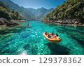 friends on a yellow raft in the emerald blue River with the sun shining and mountains 129378362