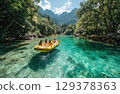 friends on a yellow raft in the emerald blue River with the sun shining and mountains 129378363