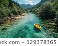 friends on a yellow raft in the emerald blue River with the sun shining and mountains 129378365