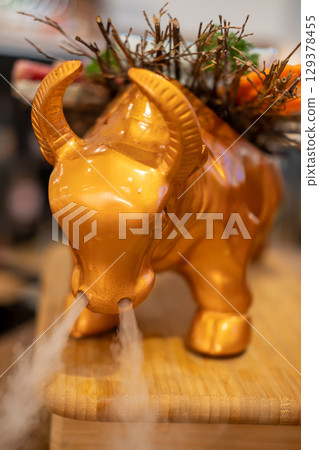 Golden cow shaped plate for Japanese style sliced wagyu beef. Golden cow shaped plate for Japanese style sliced wagyu beef. 129378455