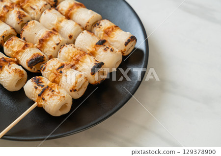 grilled tube shaped fish paste cake skewe or tube squid skewer grilled tube shaped fish paste cake skewe or tube squid skewer 129378900