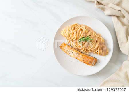 grilled salmon with spaghetti creamy tomato sauce grilled salmon with spaghetti creamy tomato sauce 129378917