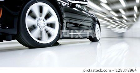 Blurred motion of car wheel during high-speed travel on road Blurred motion of car wheel during high-speed travel on road 129378964