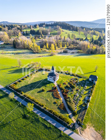 Tesarov Chapel nestled in a small graveyard, surrounded by lush greenery in Korenov, Jizera Mountains. The serene landscape highlights the beauty of Czechia. Tesarov Chapel nestled in a small graveyard, surrounded by lush greenery in Korenov, Jizera Mountains. The serene landscape highlights the beauty of Czechia. 129379990