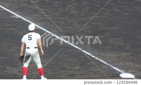 High school baseball player playing third base 129380496