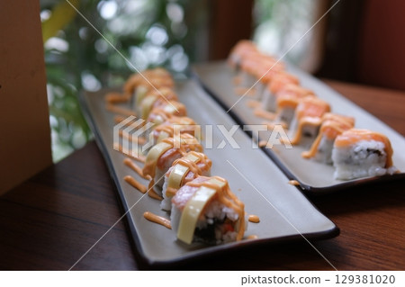 Sushi rolls sauce close-up sushi rolls set rotates. sushi delivery concept. appetizing sushi macro 129381020