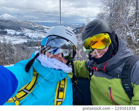 Skiers Taking Selfie on Snowy Mountain Skiers Taking Selfie on Snowy Mountain 129381838