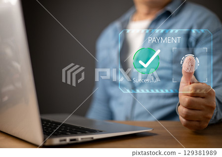 A person uses a biometric fingerprint scan for an online payment on a laptop.futuristic digital interface displays PAYMENT Successful with a green checkmark, symbol secure transactions. A person uses a biometric fingerprint scan for an online payment on a laptop.futuristic digital interface displays PAYMENT Successful with a green checkmark, symbol secure transactions. 129381989