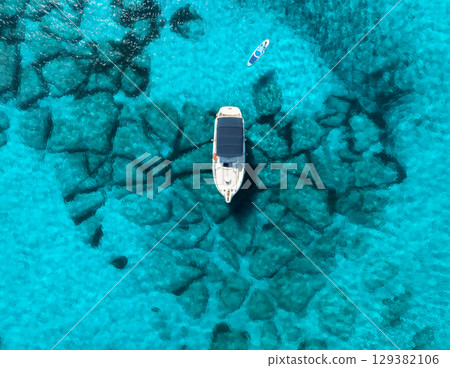 Aerial view of Yacht anchored in crystal clear turquoise sea 129382106