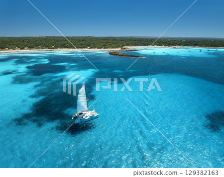 Aerial view of sailboat, turquoise sea near Mallorca sandy beach Aerial view of sailboat, turquoise sea near Mallorca sandy beach 129382163