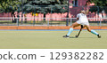 Female athlete passing the ball over the field. 129382282