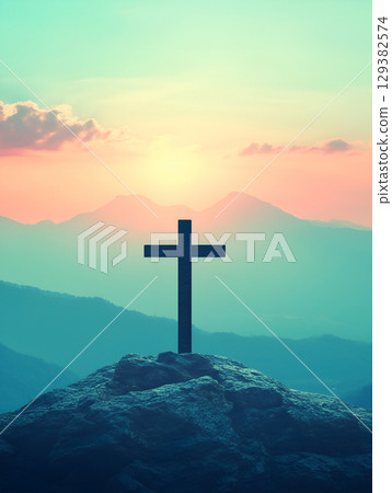Crucifix symbolizing faith against a vibrant sunset over the mountains Crucifix symbolizing faith against a vibrant sunset over the mountains 129382574