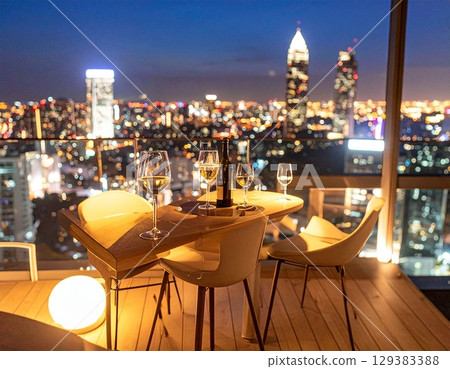 Romantic table setting at a luxury bar and restaurant with a night view Romantic table setting at a luxury bar and restaurant with a night view 129383388