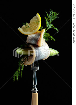 Herring fillet in oil with lemon, cucumber, and dill. Herring fillet in oil with lemon, cucumber, and dill. 129383545