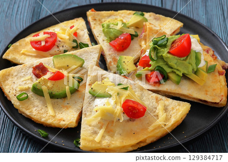 quesadilla with cheese, bacon, avocado on a plate 129384717