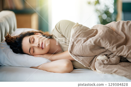 Woman is sleeping in her bedroom Woman is sleeping in her bedroom 129384828