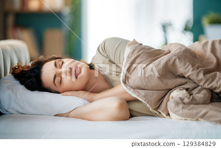 Woman is sleeping in her bedroom 129384829