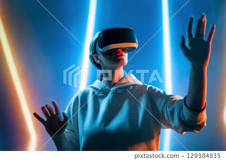 Woman with VR virtual reality goggles 129384835