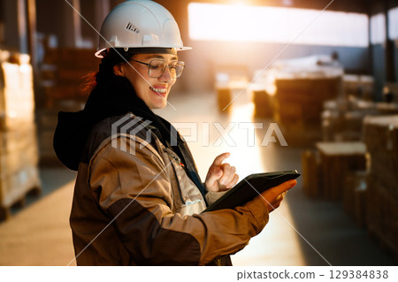 Young woman is working in warehouse Young woman is working in warehouse 129384838