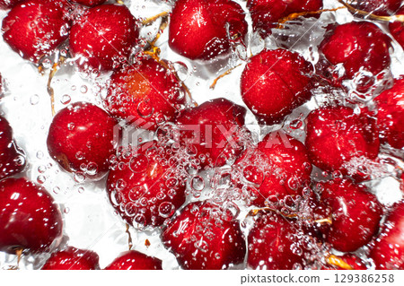 Red Sweet Cherries with Water Splash from Above. Red Sweet Cherries with Water Splash from Above. 129386258