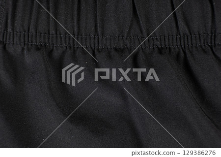 Old worn-out polyester and elastane fabric, pilling and frayed threads 129386276