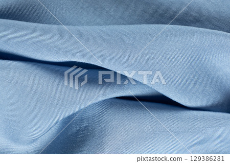 Smooth Blue Fabric Background with Artistic Abstract Design and Text Space Smooth Blue Fabric Background with Artistic Abstract Design and Text Space 129386281