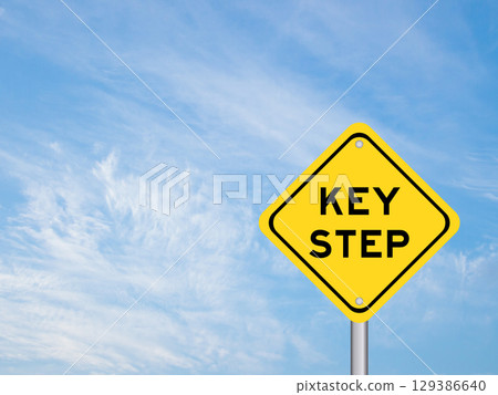 Yellow transportation sign with word key step key step on blue color sky background 129386640